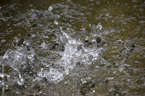 water splash or water movement like frozen water drops, water surface splash in a fountain