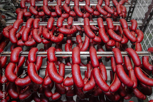 Sausage. Sausage production line. Sausage on the counter for the smokehouse. Industrial manufacture of sausages. Meat shop photo