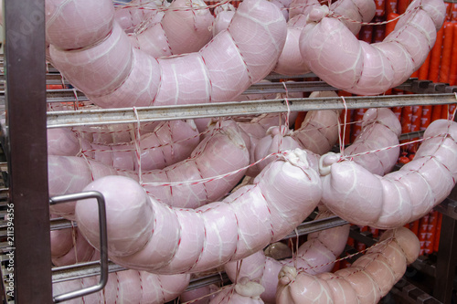 Sausage. Sausage production line. Sausage on the counter for the smokehouse. Industrial manufacture of sausages. Meat shop photo