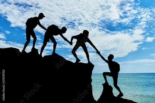 Conceptual scene of male mountaineers work in a team
