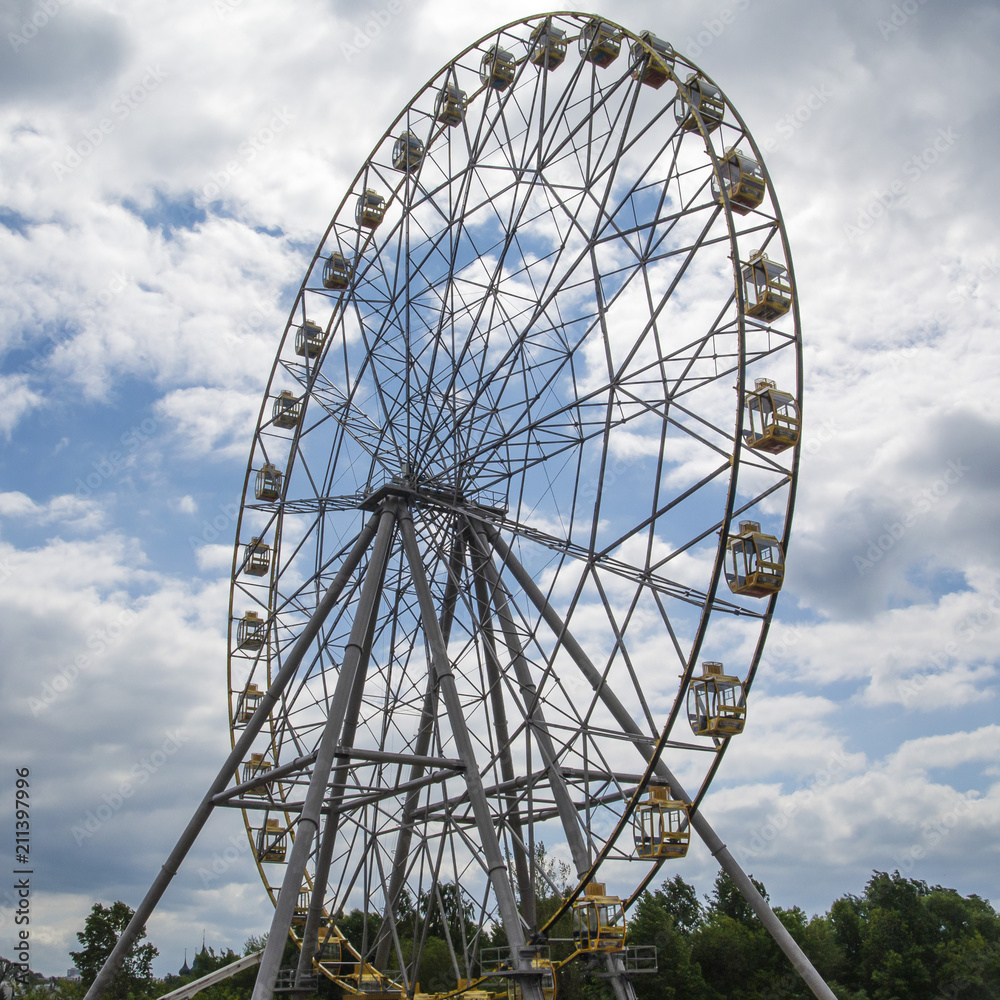 Ferris Wheel Against a Bright Blue Sky with Clouds