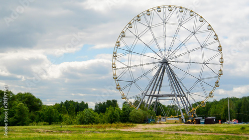 Ferris Wheel Against a Bright Blue Sky with Clouds