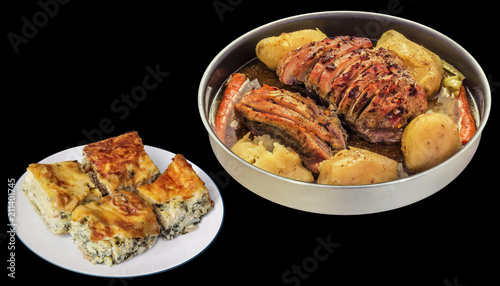 Pork Ham Slices Oven Baked with Whole Potatoes Served with Cheese and Spinach Pie Isolated on Black Background