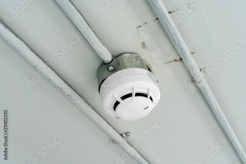 Smoke detector sensor on cement ceiling in parking