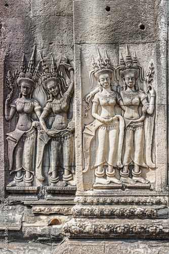 Apsaras, four dancing girls at stone facade of Angkor Wat Temple in Angkor, Cambodia.