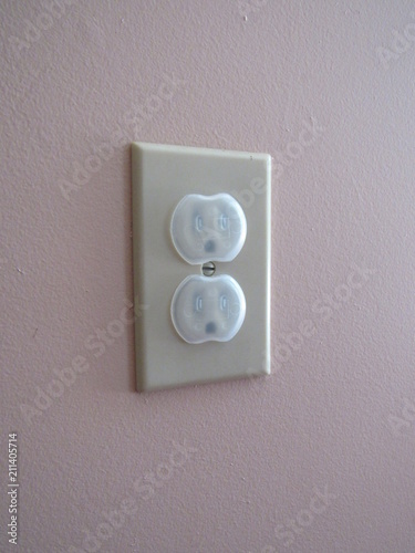 An American outlet with safety childproof outlet covers on them 