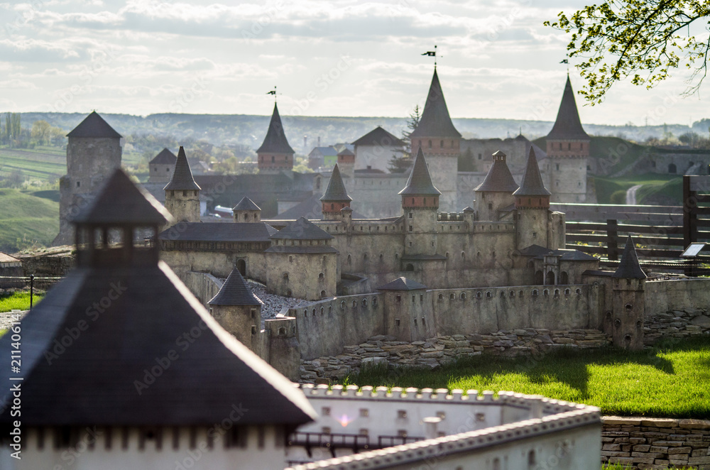 A model of a medieval fortress against the backdrop of a real fortress A model of a medieval fortress against the backdrop of a real fortress