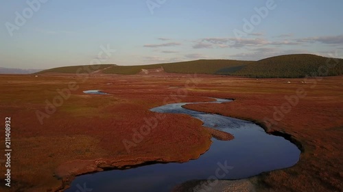 Aerial view from a drone of a river in a Mongolian steppe on an autumn day. Lake Khuvsgol, Mongolia. photo