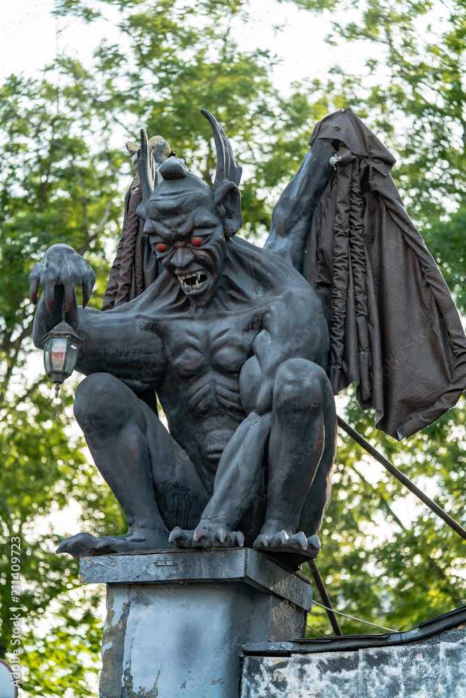 Gargoyle statue in the park. Stone sculpture