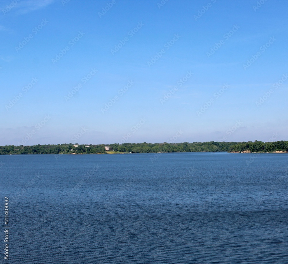 A beautiful view of the lake in the park on a sunny day. A beautiful view of the lake in the park on a sunny day.