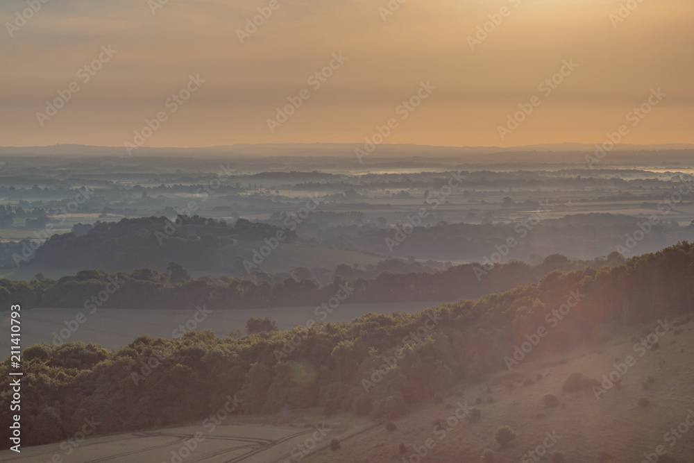 Sunrise and a low lying mist over the South Downs in Sussex