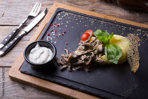 Beef stroganoff served with mashed potato photo