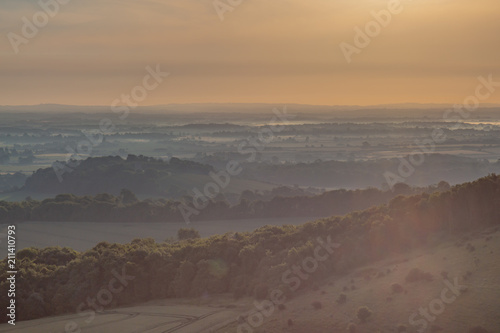 Sunrise and a low lying mist over the South Downs in Sussex