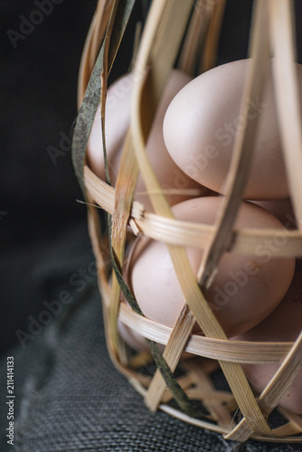 Egg in bamboo basket with rustic background
