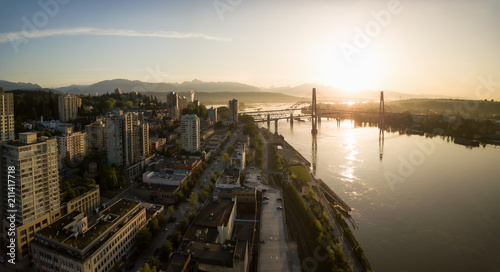 Aerial Panoramic view of Fraser River and Bridges during a vibrant sunrise. Taken in New Westminster, Greater Vancouver, British Columbia, Canada. © edb3_16