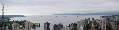 Aerial panoramic view of Downtown City Buildings overlooking the ocean during a cloudy overcast day. Taken in Vancouver, BC, Canada. © edb3_16