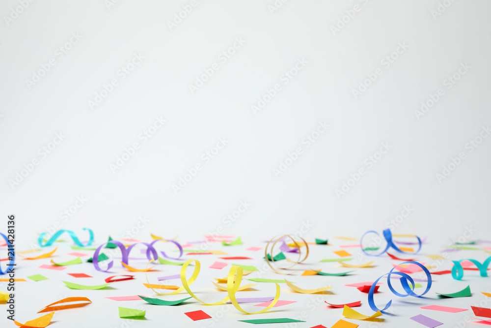 Colorful confetti and streamers on white background Colorful confetti and streamers on white background