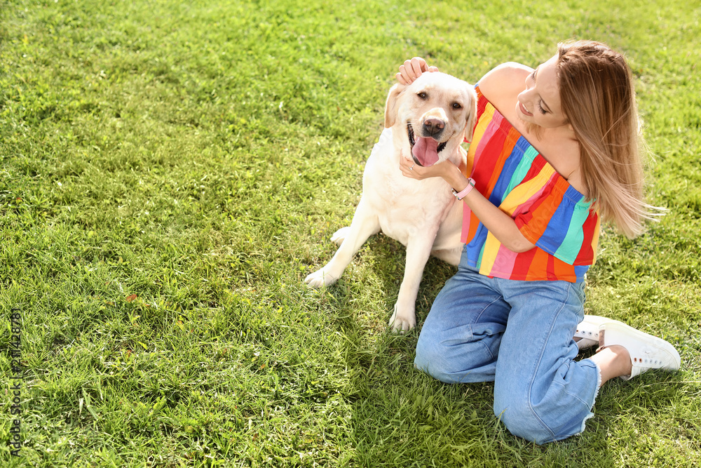 Cute yellow labrador retriever with owner outdoors Cute yellow labrador retriever with owner outdoors