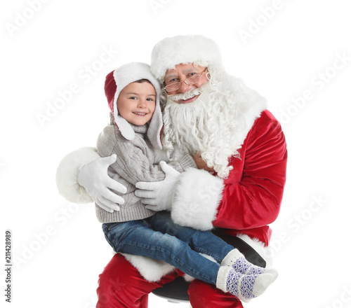 Little boy hugging authentic Santa Claus on white background