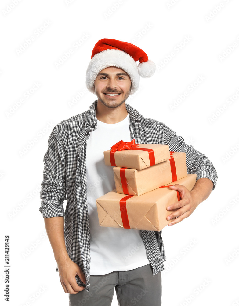 Young man with Christmas gifts on white background