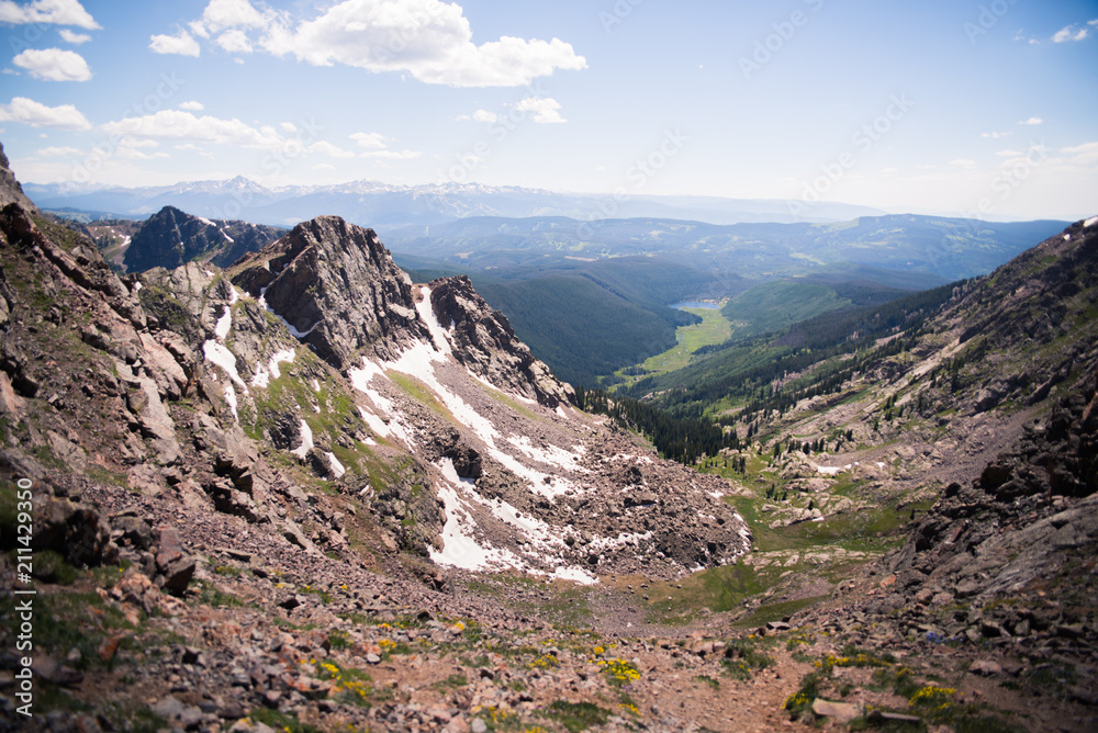 Landscape view overlooking Piney Lake and the Rocky Mountains from the summit of the Gore Range, 