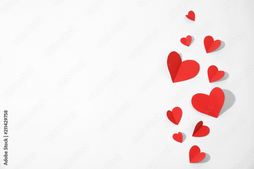 Small paper hearts on white background