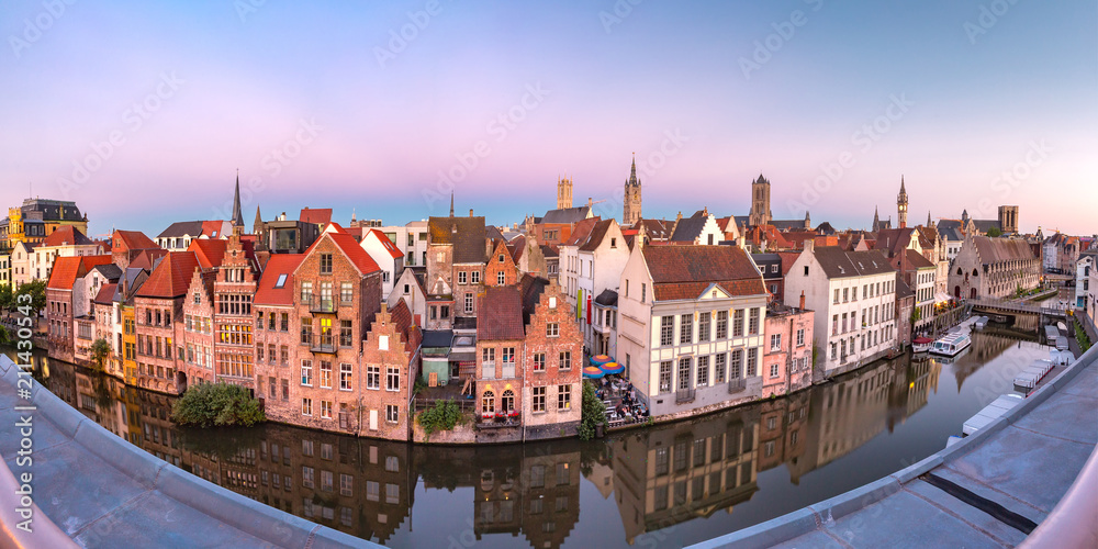 Fototapeta premium Panoramic aerial view of picturesque medieval buildings on the quay Graslei, Leie river and towers of Old Town at sunset, Ghent, Belgium