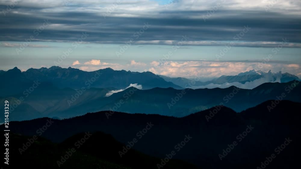 Silhouette Of The Mountain range Against The Moving Clouds Silhouette Of The Mountain range Against The Moving Clouds