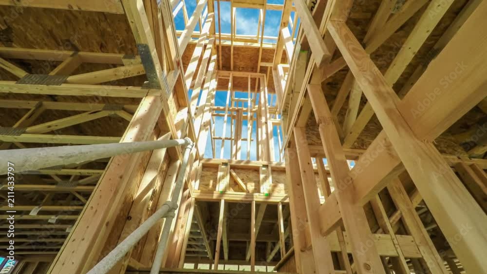 Moving through a modern home construction site under bright sunlight Moving through a modern home construction site under bright sunlight