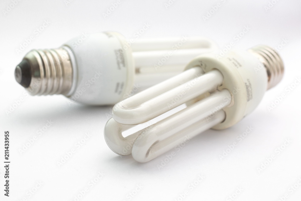 Old compact fluorescent lamp on white background. Old compact fluorescent lamp on white background.