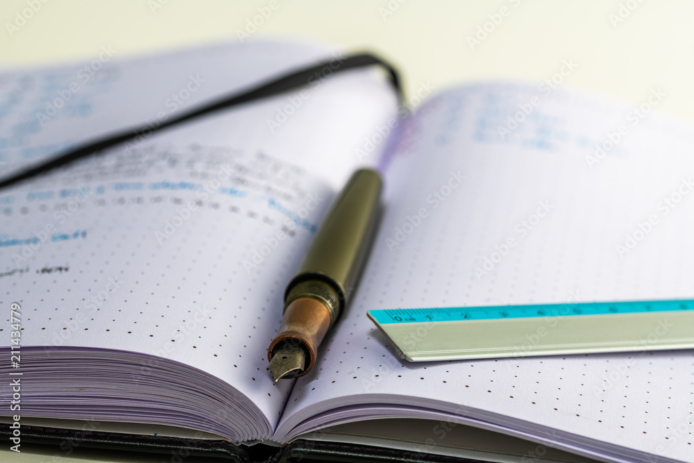 Notebook with writing, ruler, pencil, fountain pen Notebook with writing, ruler, pencil, fountain pen