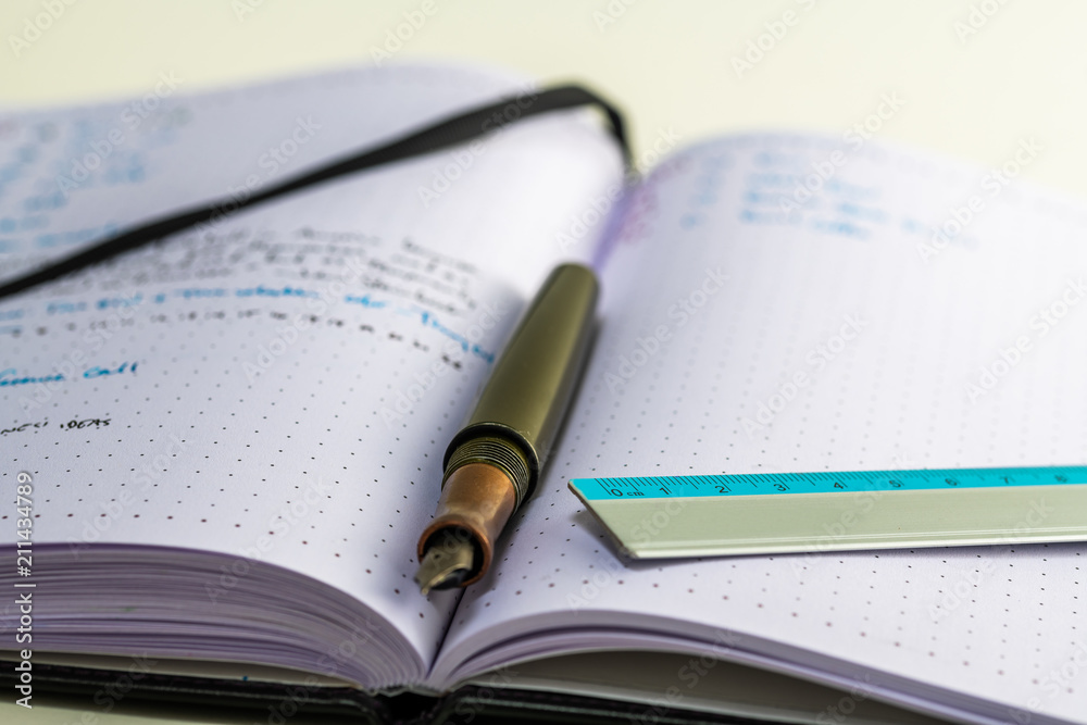 Notebook with writing, ruler, pencil, fountain pen Notebook with writing, ruler, pencil, fountain pen