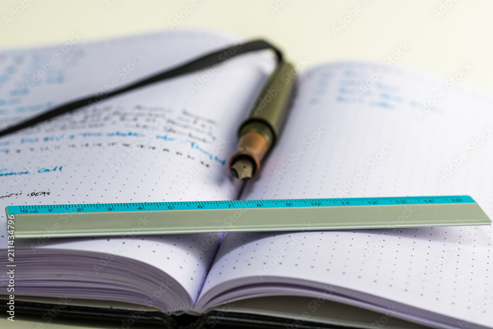 Notebook with writing, ruler, pencil, fountain pen Notebook with writing, ruler, pencil, fountain pen