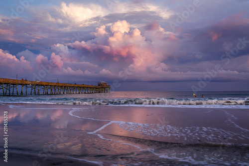 Fototapeta Naklejka Na Ścianę i Meble -  Pier with Beach Sunset and Clouds