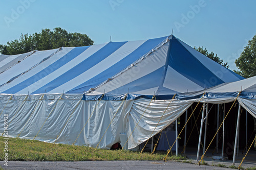 A big blue and white tent under blue skies on a nice spring day in Missouri.
