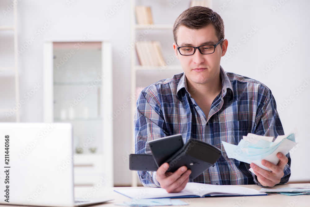 Young man frustrated at his house and tax bills Young man frustrated at his house and tax bills