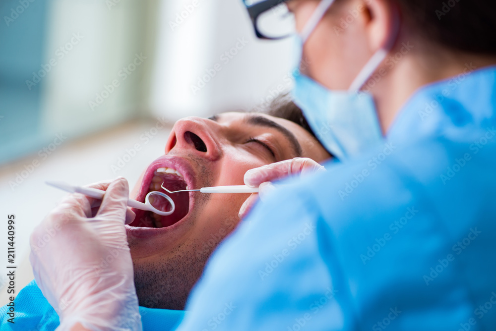 Fototapeta premium Man patient visiting dentist for regular check-up