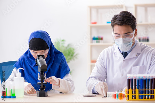 Two chemists working in the lab