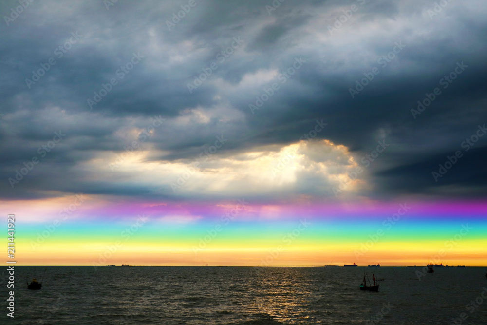 Obraz premium rainbow back dark cloud on sea. concept god bless, wish