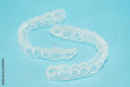 Dental tools and retainer orthodontic appliance on the blue background.