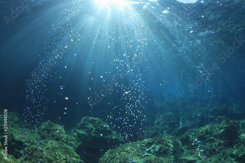 Underwater ocean background with air bubbles in water 