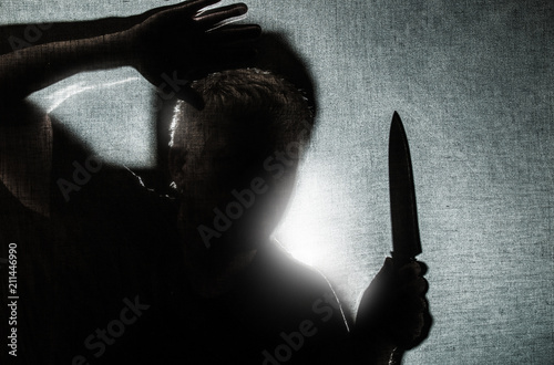 Obraz na plátne a man is threateningly holding a knife in his hand