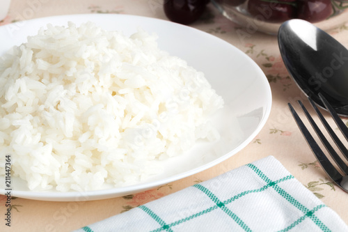 Cooked plain white jasmine rice serve in. a dish. Close up on the table. Horizontal