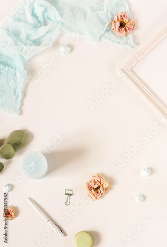 Creative festive composition with  frame mock up, pink blanket, flowers, eucalyptus branches, roses on white background. Flat lay, top view stylish template. 