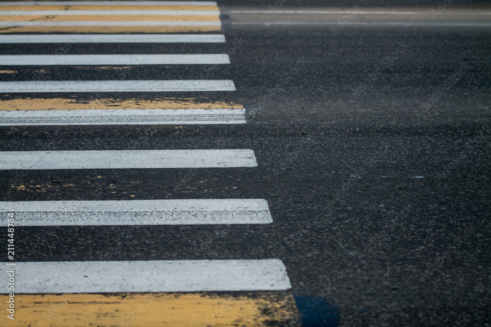 background: white and yellow zebra crossing with the part of clear gray asphalt as a copy space background: white and yellow zebra crossing with the part of clear gray asphalt as a copy space