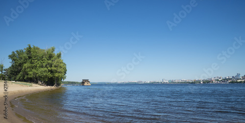 View of the city from the opposite Bank of the Volga river in Samara, Russia. On a Sunny summer day. 28 June 2018 © butenkow