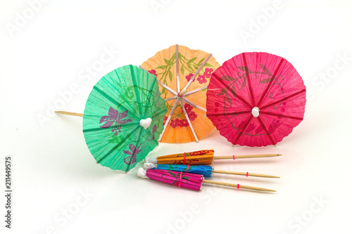 Close up colorful of many  cocktail umbrellas on white  background