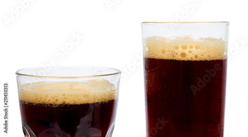 Cold glass of dark beer or kvass with foam isolated on white background.