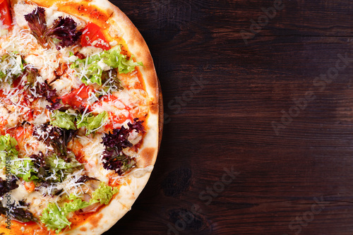 Restaurant, food delivery, pizzeria menu concept. Appetizing vegetarian pizza with lettuce ad garlic sauce flat lay with copy space. Delicious classical recipe, traditional Italian snack
