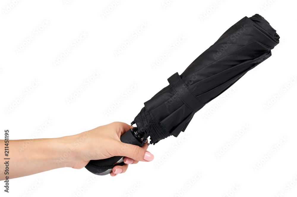Fototapeta premium Single closed black umbrella with hand isolated on a white background.